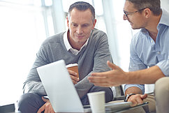Teamwork, research or business people with laptop in office for